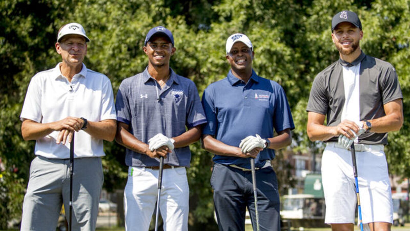 Callaway Golf CEO Oliver Brewer III, Howard student Otis Ferguson IV, Howard President Wayne Frederick and Steph Curry pose for photographs before teeing off together at Langston Golf Course in Washington on Aug. 19.