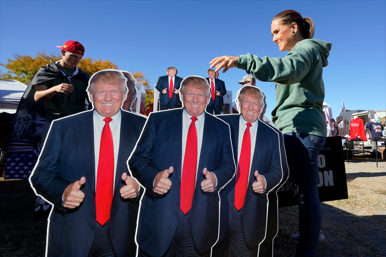 Whitney Bruce of Roanoke, Va., looks at items for sale before Republican presidential nominee former President Donald Trump speaks at a campaign rally in Salem Va., Saturday, Nov 2, 2024. (AP Photo/Steve Helber)