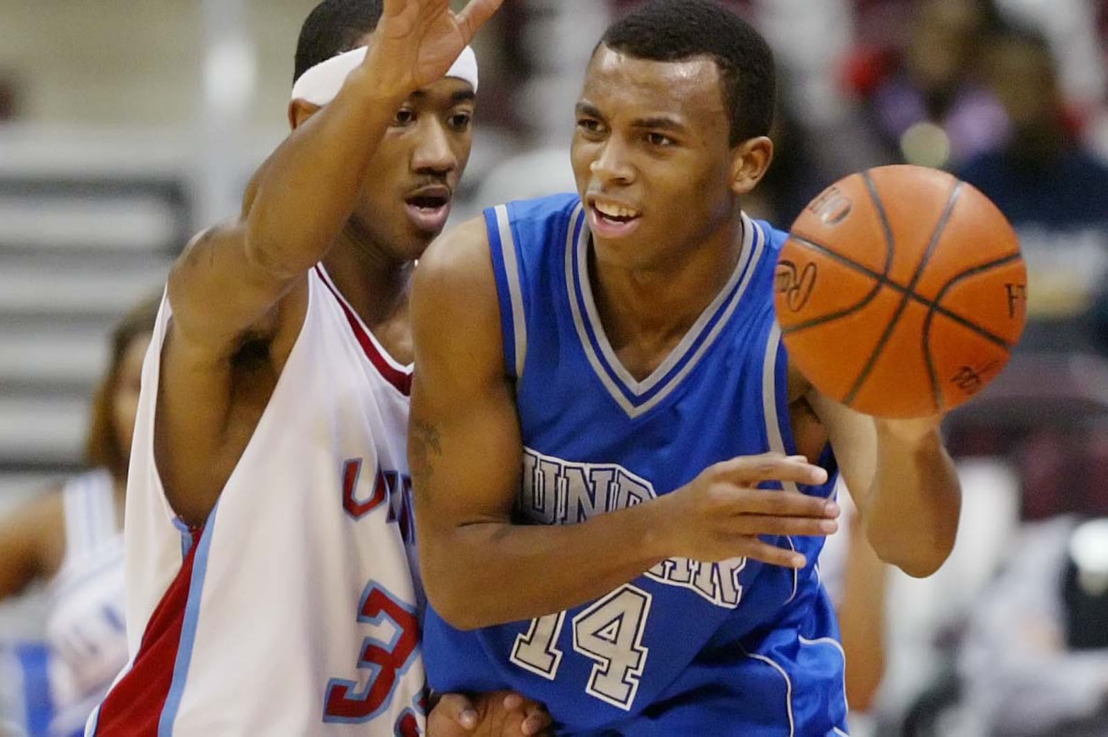 Dunbar’s Daequan Cook dishes off a pass around the defense of Villa Angela St. Joseph’s Dave Lighty in the third quarter of their game at the Schottenstein Center in Columbus, Ohio Jan. 16, 2006. FILE PHOTO