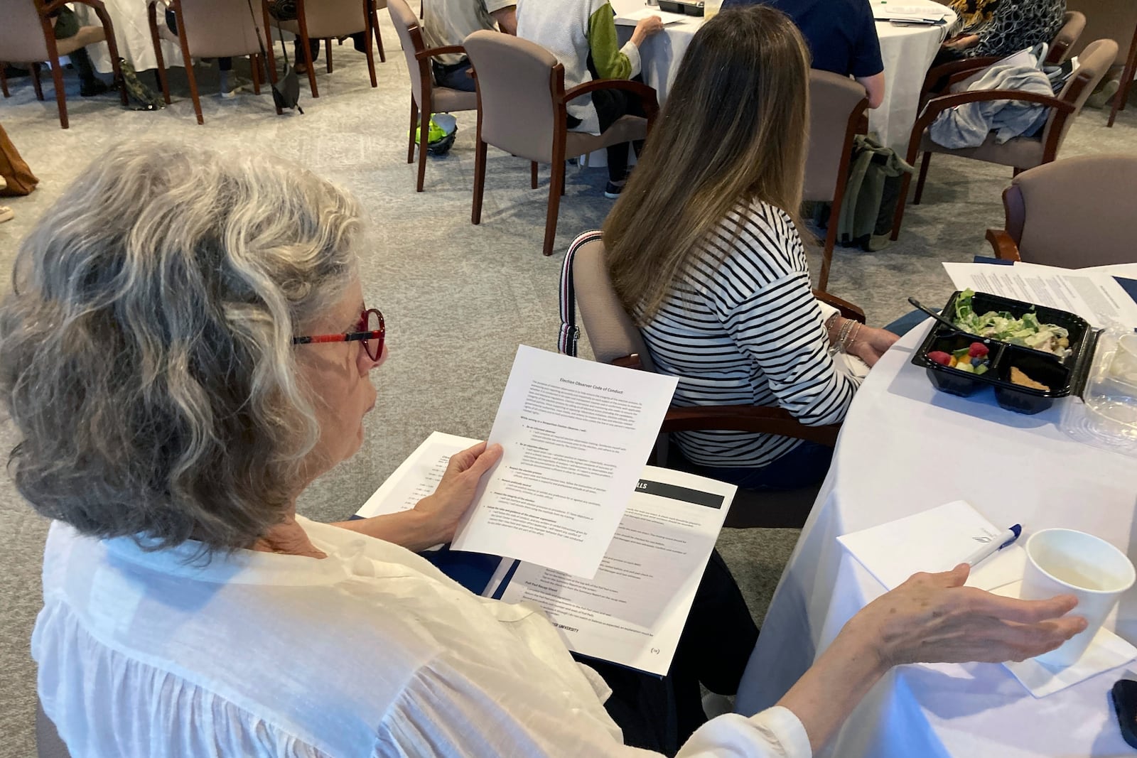 FILE - A volunteer election observer reviews training materials on Nov. 6, 2022, at the Carter Center in Atlanta. (AP Photo/Jeff Amy, File)