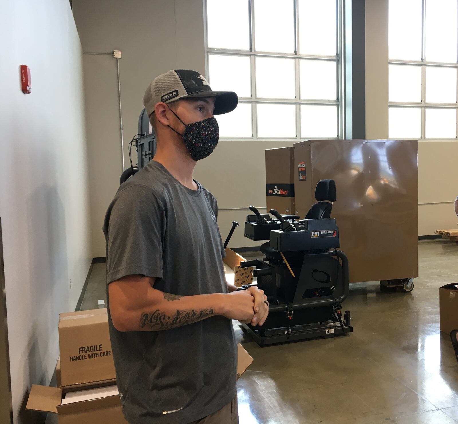 A construction sciences teacher at the Greene County Career Center explains the Caterpillar simulator and it's benefits in the classroom. STAFF/BONNIE MEIBERS