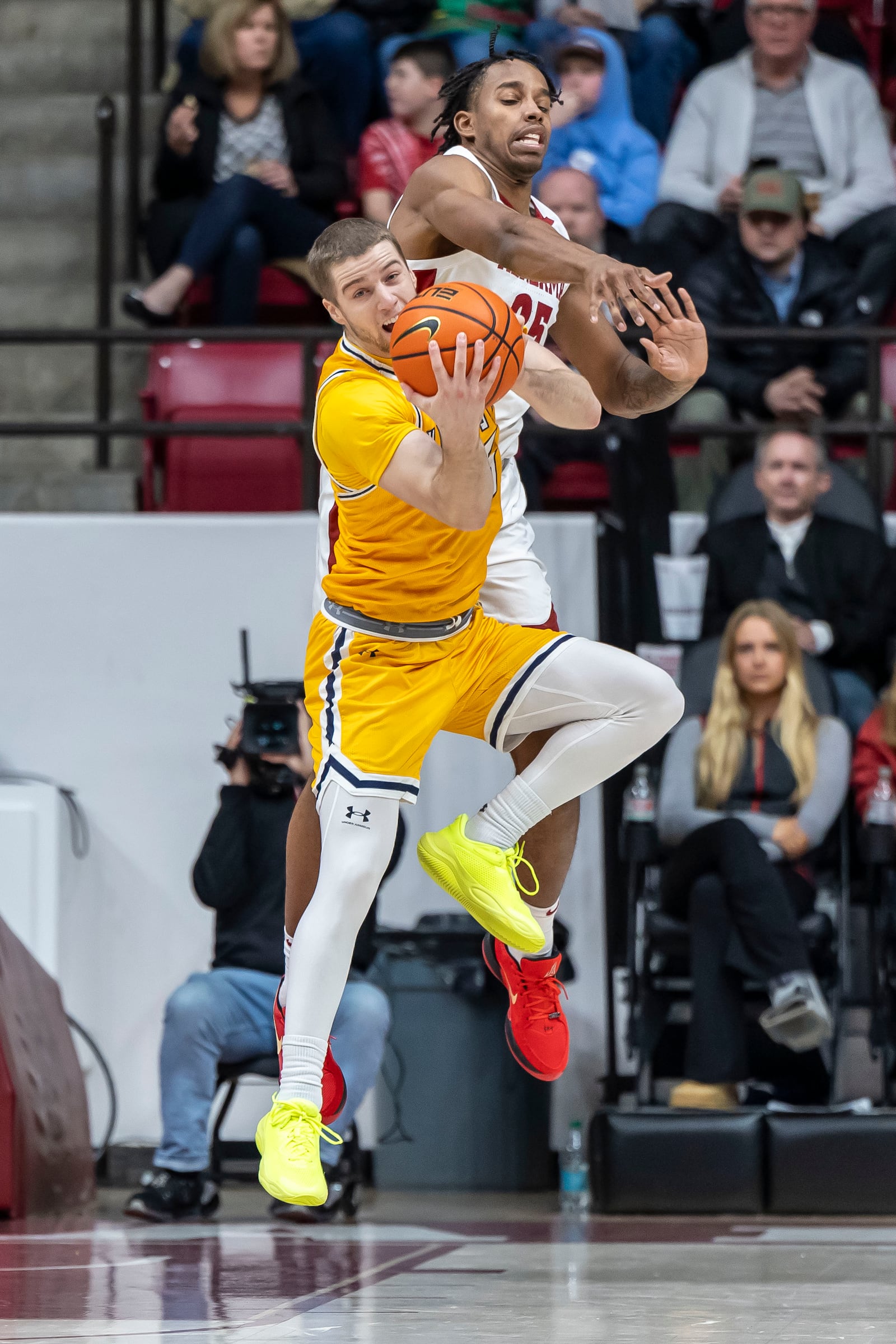 Kent State guard Mike Bekelja (15) rebounds the ball and draws a foul from Alabama forward Derrion Reid (35), during the first half of an NCAA college basketball game, Sunday, Dec. 22, 2024, in Tuscaloosa, Ala. (AP Photo/Vasha Hunt)