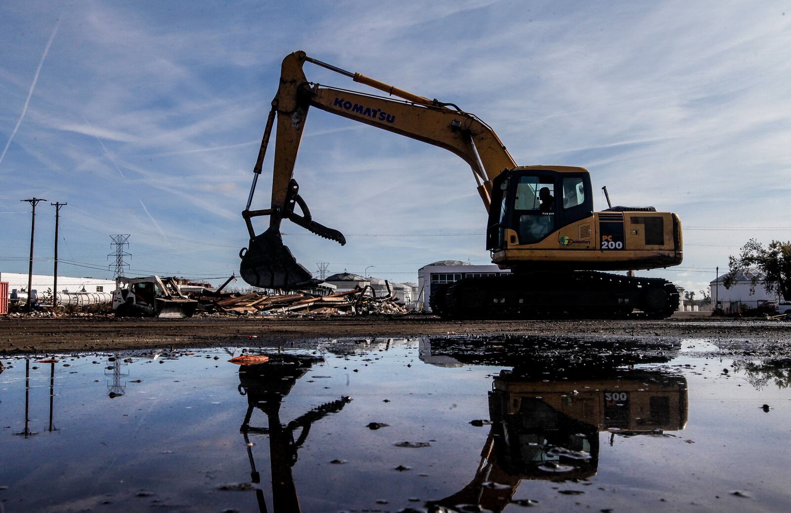 Workers with Bladecutters, Inc., clean up tornado-damaged properties, including where Innovative Weld Solutions’ building was destroyed on Farr Drive in Old North Dayton. CHRIS STEWART / STAFF