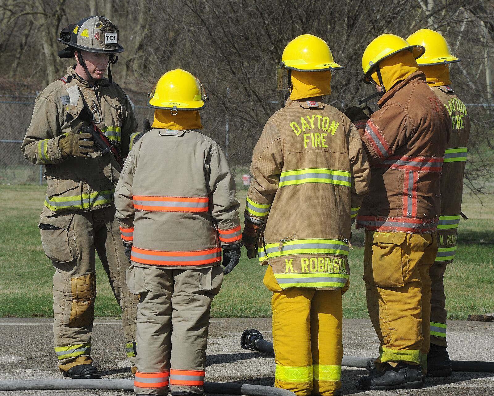 Captain Brad French of the Dayton Fire Department, left, instructs students, during fire training Wednesday, March 24, 2021 for the Dayton Public School District and the City of Dayton Fire/EMS CTE program. MARSHALL GORBY\STAFF