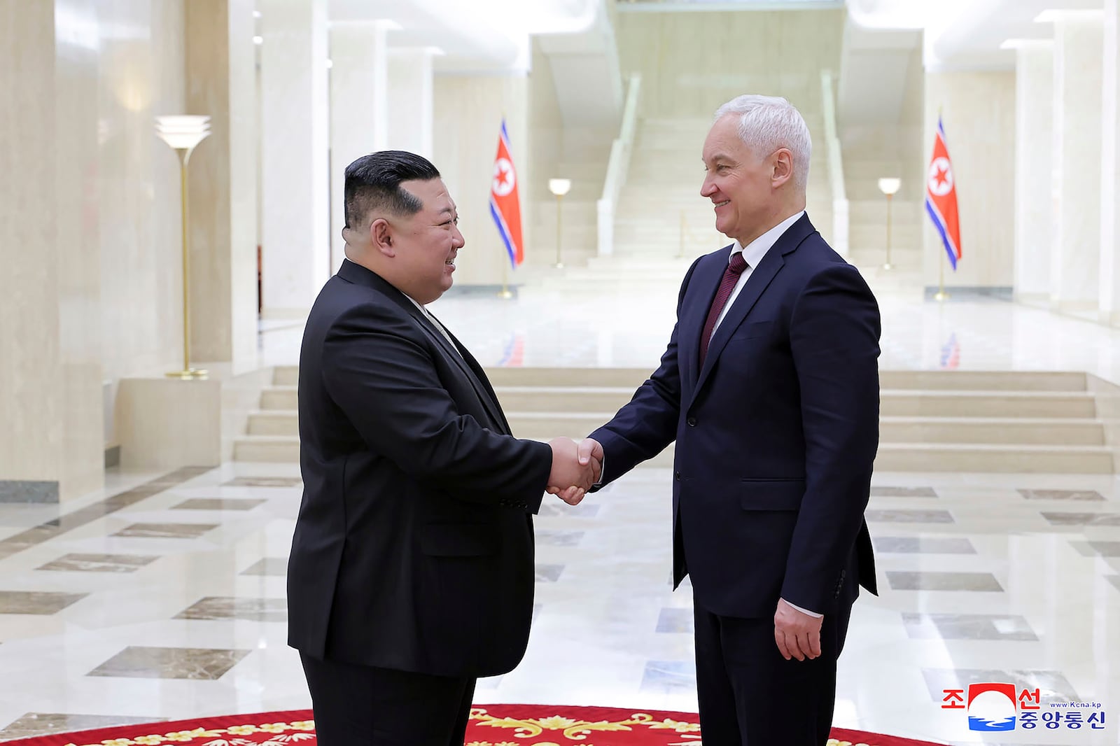 In this photo provided by the North Korean government, North Korean leader Kim Jong Un, left, shakes hands with Russian Defense Minister Andrei Belousov in Pyongyang, North Korea Friday, Nov. 29, 2024. Independent journalists were not given access to cover the event depicted in this image distributed by the North Korean government. The content of this image is as provided and cannot be independently verified. Korean language watermark on image as provided by source reads: "KCNA" which is the abbreviation for Korean Central News Agency. (Korean Central News Agency/Korea News Service via AP)