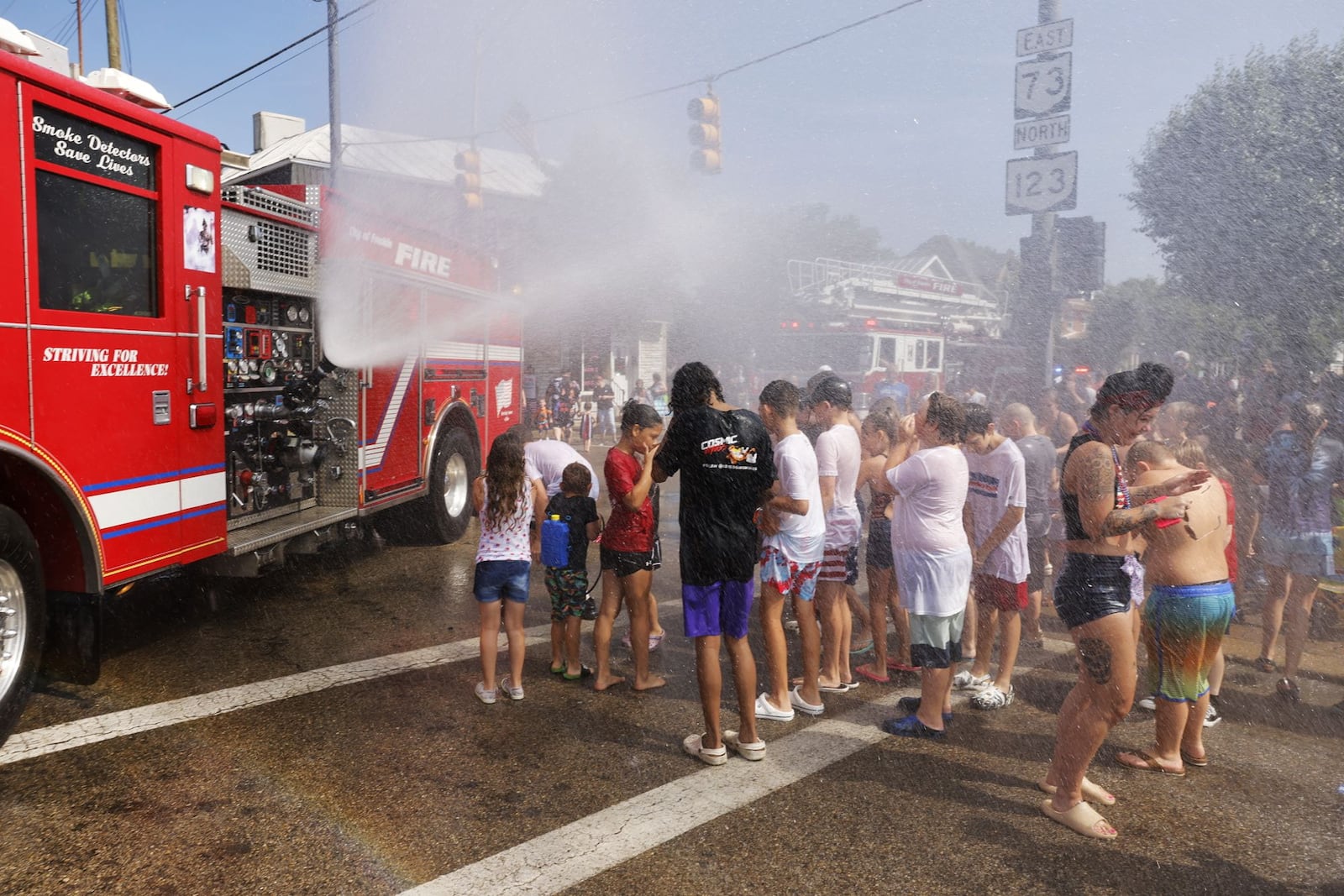 Parade attendees get drenched during Franklin's Independence Day Parade, known as "The Wettest Parade in Ohio", Tuesday, July 4, 2023 on Main Street in Franklin. Wet zones are set up at each intersection for a friendly water fight with many parade floats and fire trucks blasting water at bystanders. NICK GRAHAM/STAFF