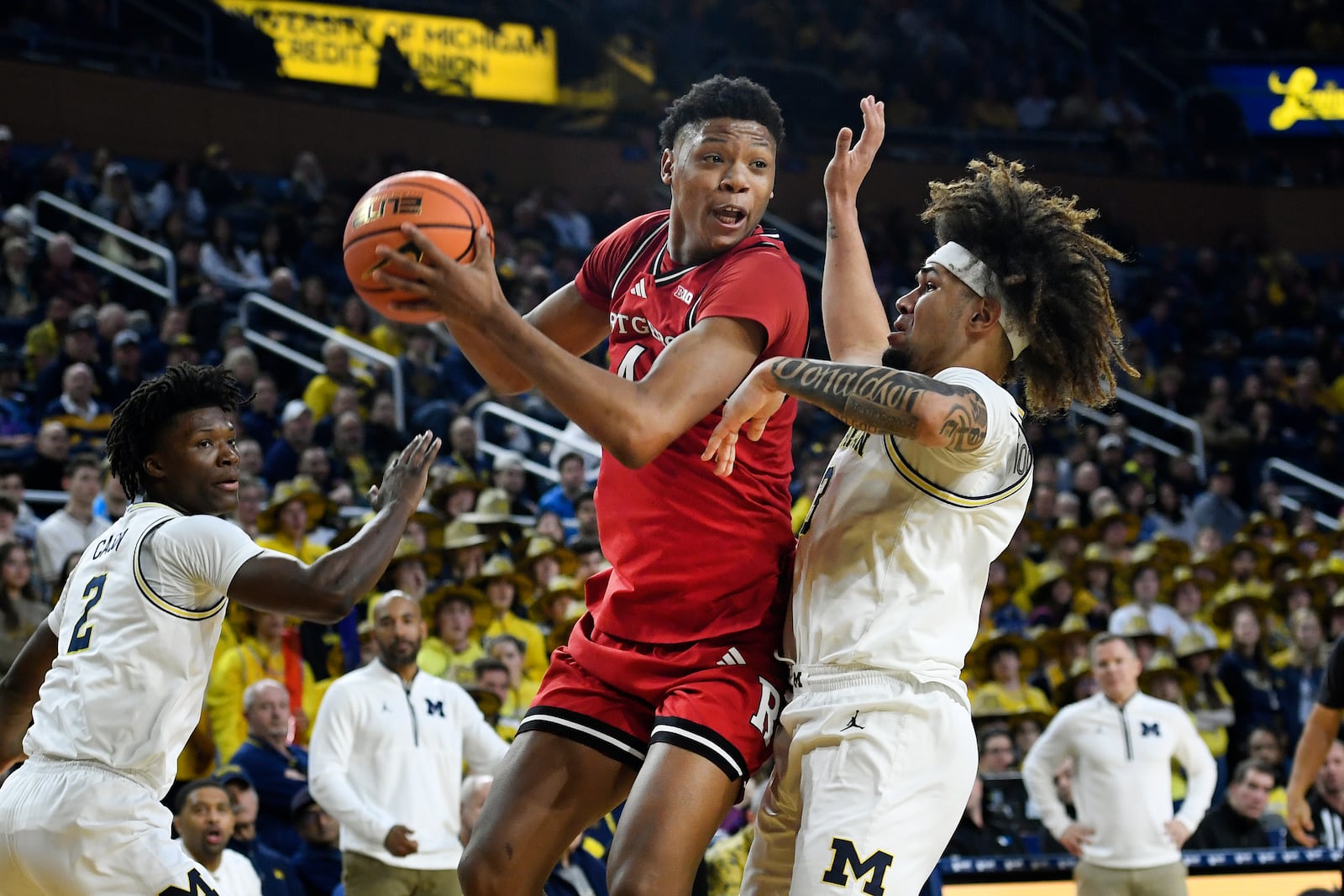 Rutgers guard Ace Bailey, middle, tries to get around Michigan guards Tre Donaldson, right, and L.J. Cason during the first half of an NCAA college basketball game, Thursday, Feb. 27, 2025, in Ann Arbor, Mich. (AP Photo/Jose Juarez)