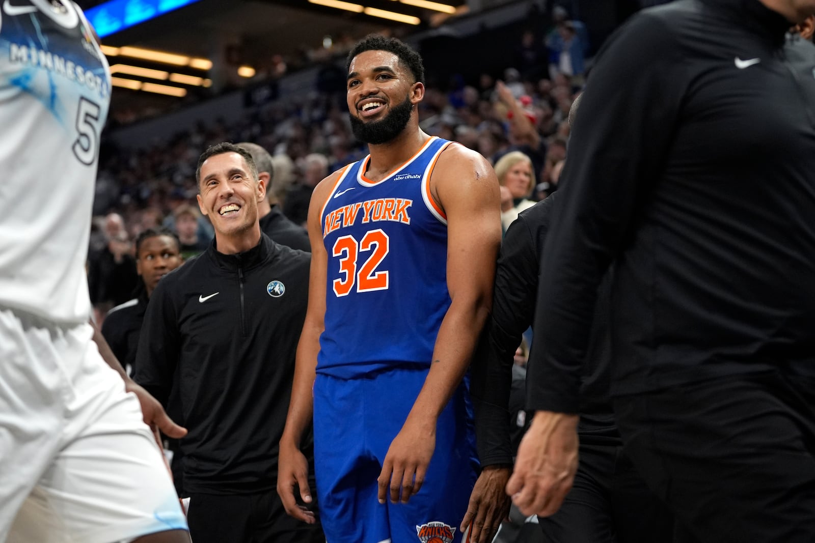 New York Knicks center Karl-Anthony Towns (32) reacts after a 3-point shot made by Minnesota Timberwolves guard Anthony Edwards at the buzzer to end the first half of an NBA basketball game, Thursday, Dec. 19, 2024, in Minneapolis. (AP Photo/Abbie Parr)