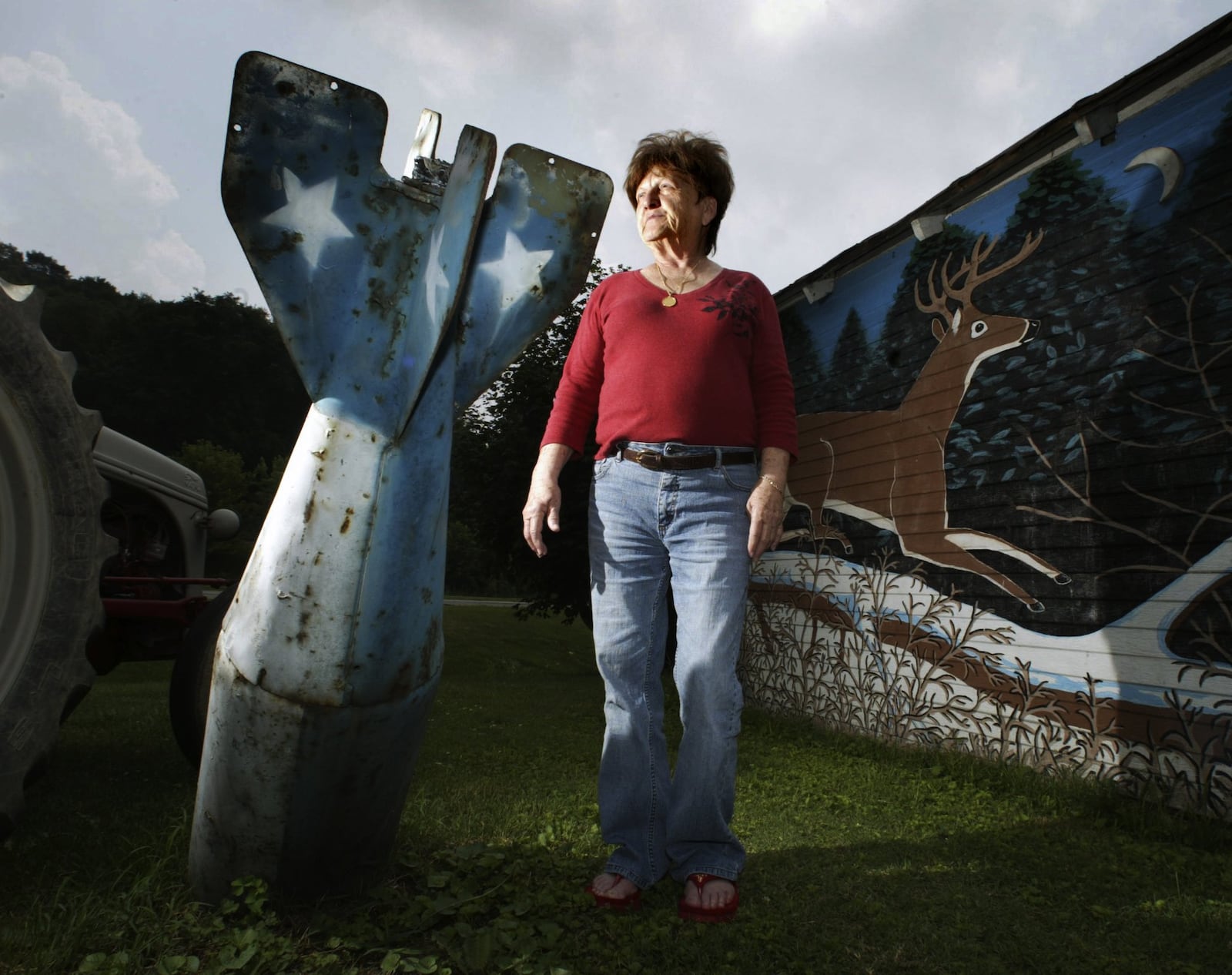 “I’m just scared of everything,” said Bonnie Louderback of Piketon. Louderback, who was interviewed in 2006 during this newspaper’s investigation of the former Portsmouth Gaseous Diffusion Plant, said she was worried about the potential of terrorists targeting of the Portsmouth nuclear facilities nearby. She has an old bomb casing in her yard. Staff photo by Chris Stewart