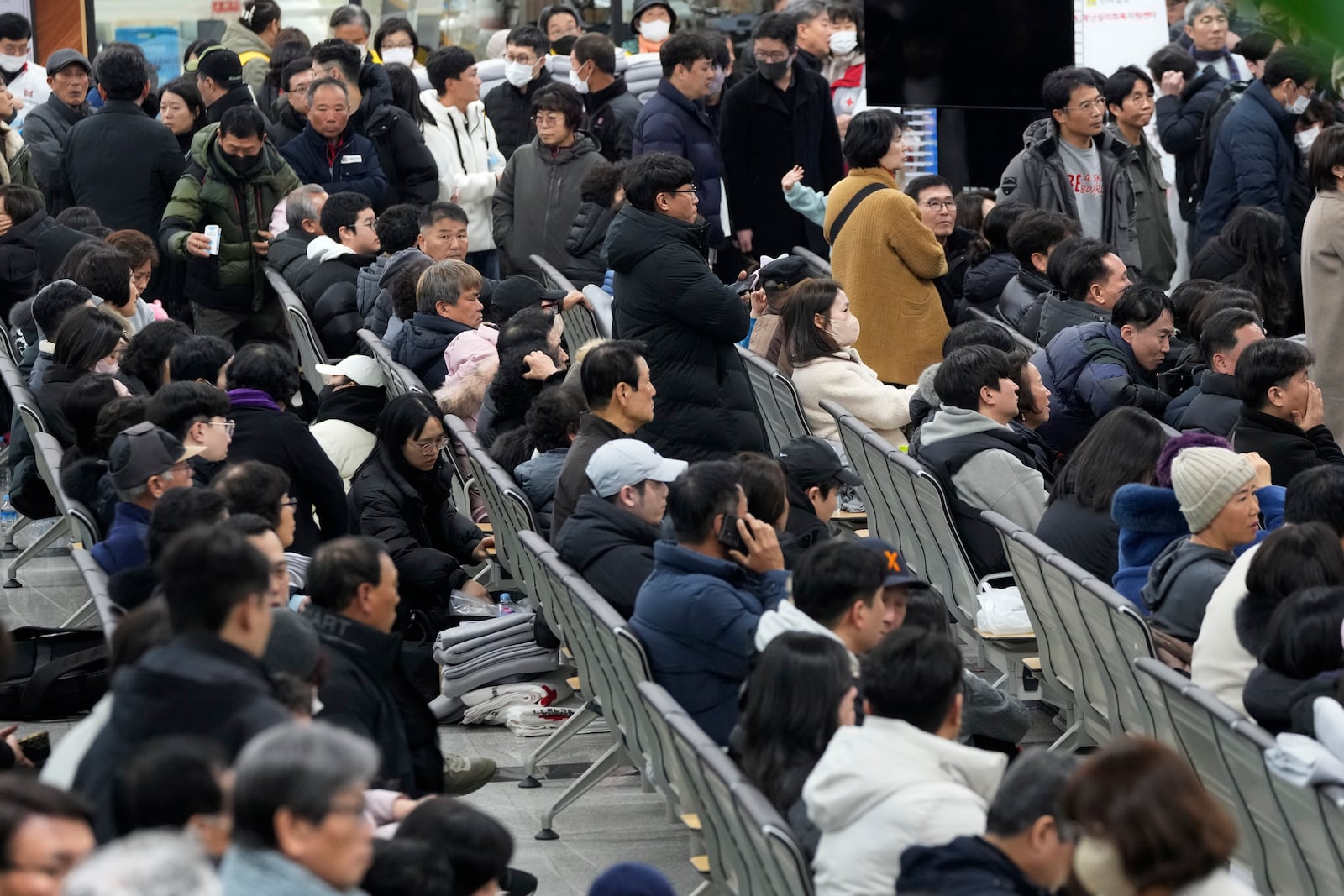 Relatives of passengers gather at Muan International Airport in Muan, South Korea, Sunday, Dec. 29, 2024, after a passenger plane crashed at the airport. (AP Photo/Ahn Young-joon)