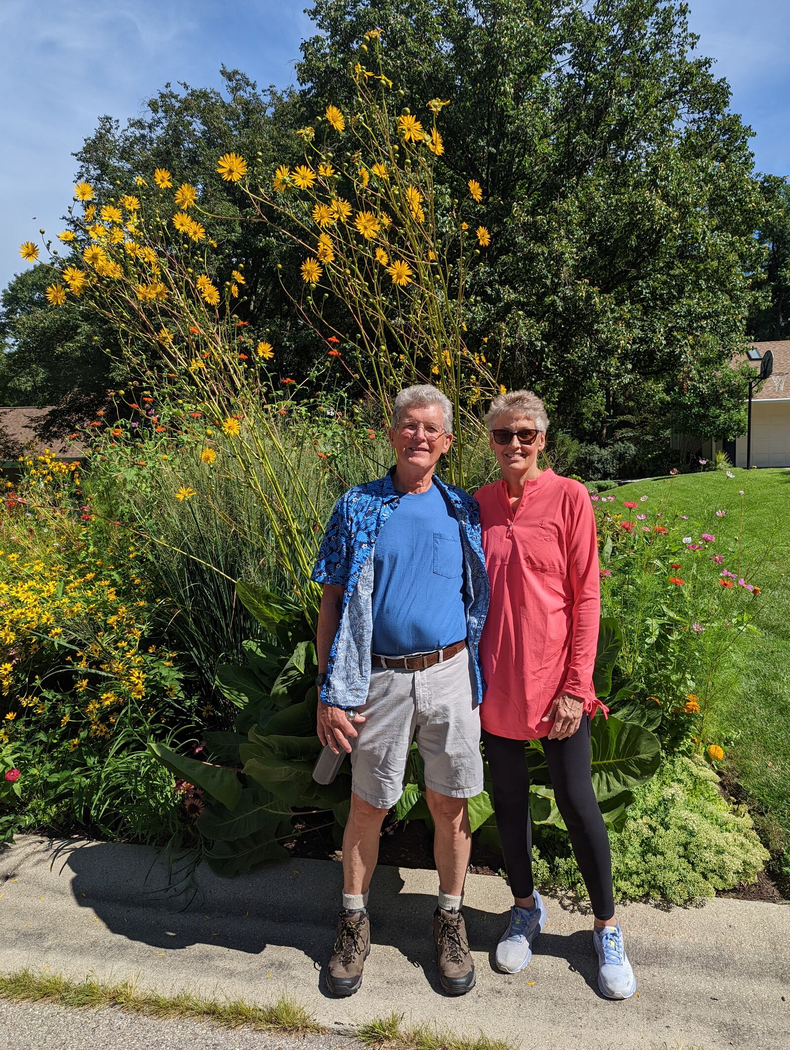 Bruce and Susan Howorth of Kettering stand in front of native prairie docks and other impressive plants in a front-yard garden. Contributed photo by Kari Carter