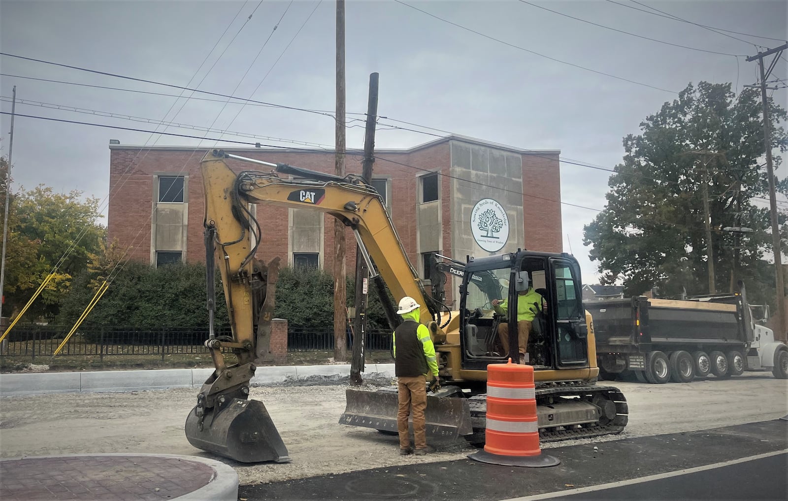 A former school building at 184 Salem Ave. in northwest Dayton. Construction crews perform roadway work in front of the building. CORNELIUS FROLIK / STAFF