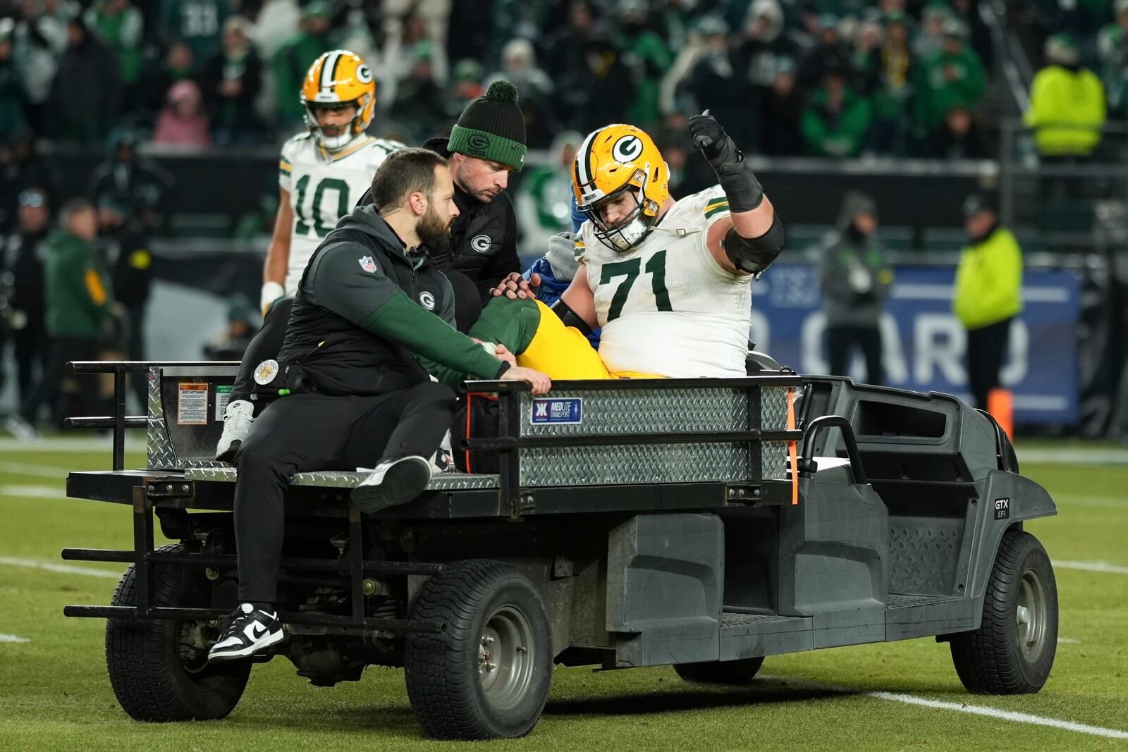 Green Bay Packers center Josh Myers (71) gestures as he is carted off the field after an injury during the second half of an NFL wild-card playoff football game against the Philadelphia Eagles on Sunday, Jan. 12, 2025, in Philadelphia. (AP Photo/Matt Slocum)