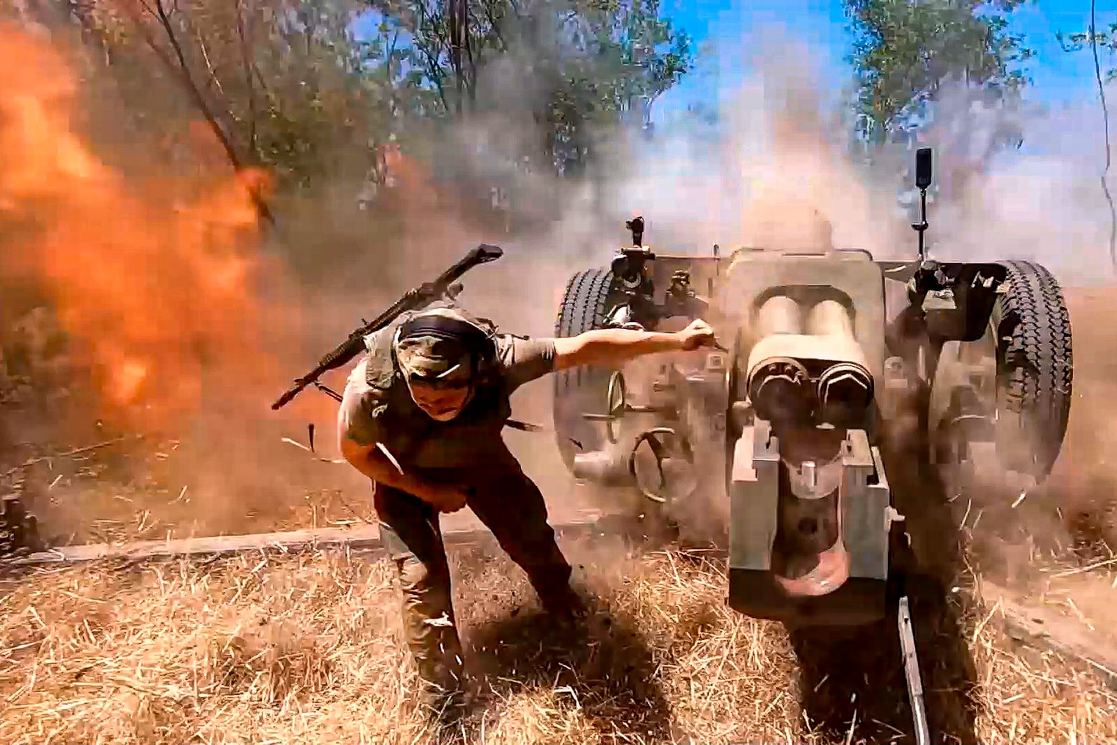 FILE - In this image made from a video released by the Russian Defense Ministry on Aug. 22, 2024, a Russian soldier fires a howitzer toward Ukrainian positions in an undisclosed location in Ukraine. (Russian Defense Ministry Press Service via AP, File)