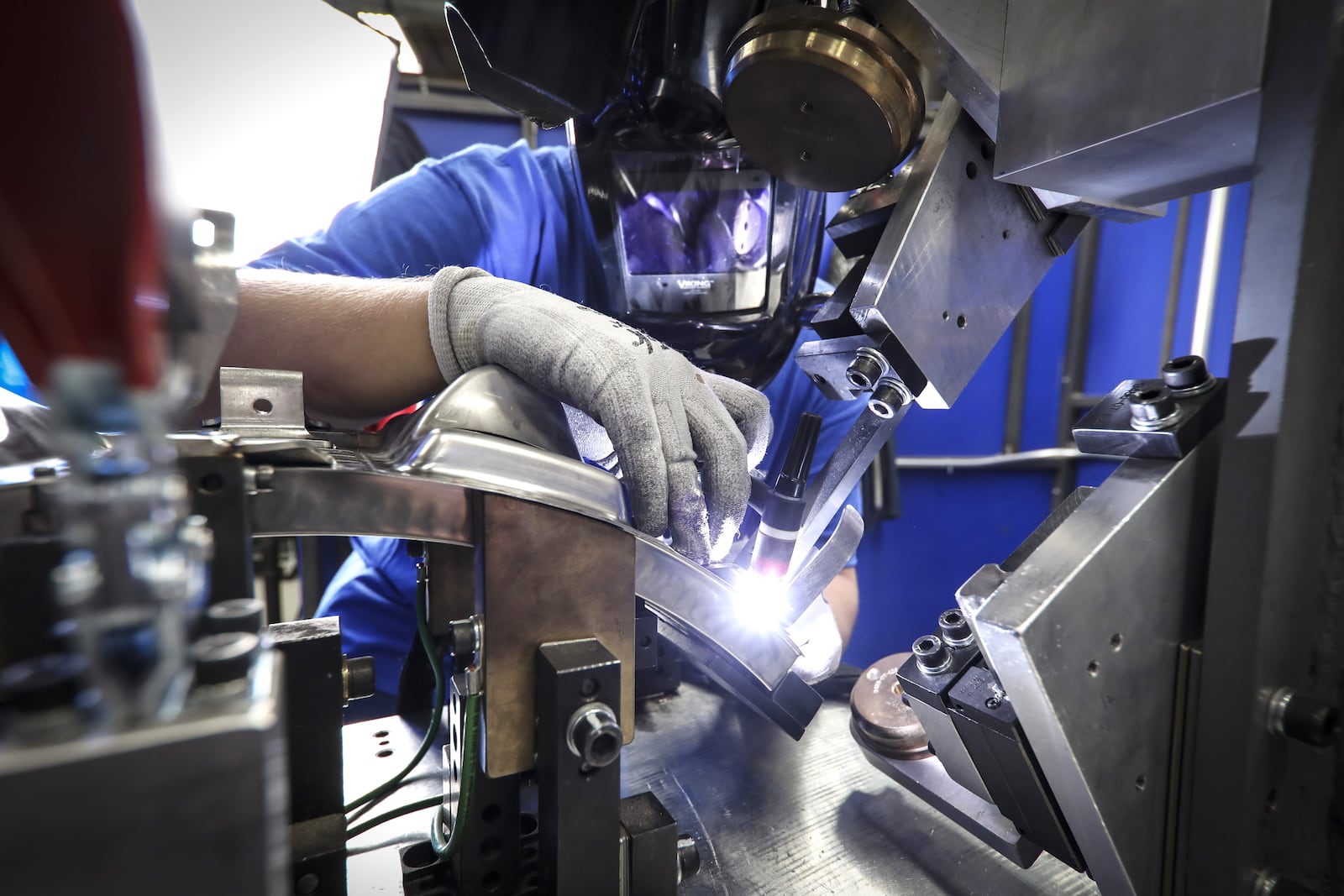 A GE Aerospace employee welds an aircraft engine component. A ribbon-cutting ceremony was held last May for a new Beavercreek facility, part of GE Aerospace’s $53.7 million investment in the past two years. CONTRIBUTED