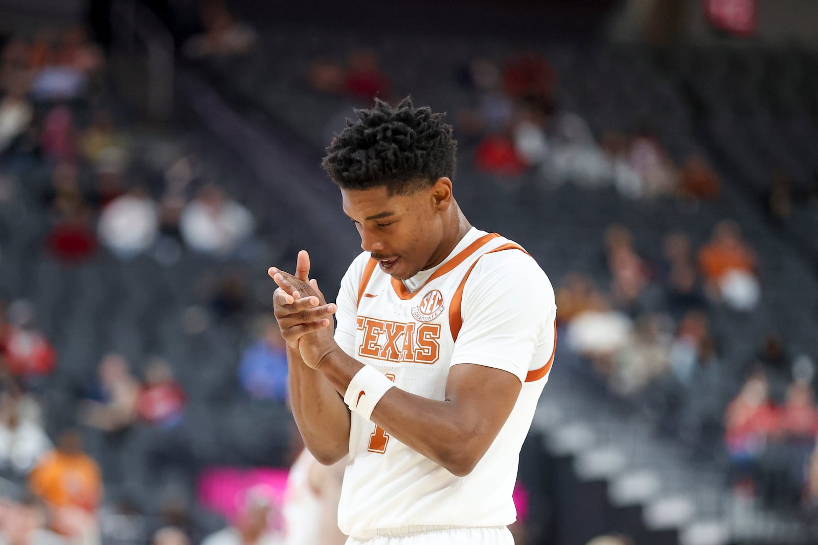 Texas guard Julian Larry (1) reacts after a timeout is called during the first half of an NCAA basketball game against Ohio State Monday, Nov. 4, 2024, in Las Vegas. (AP Photo/Ian Maule)