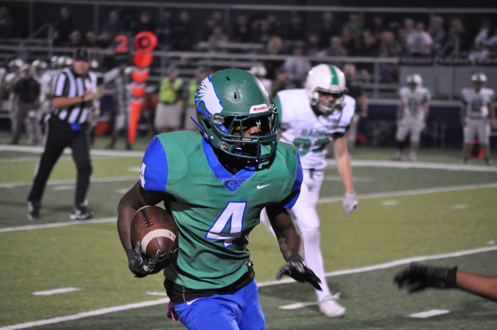 Chaminade Julienne wide receiver Keshaun Owens picks up yardage after the catch during Friday night’s game against Badin at Roger Glass Stadium in Dayton. CONTRIBUTED PHOTO BY NICK DUDUKOVICH