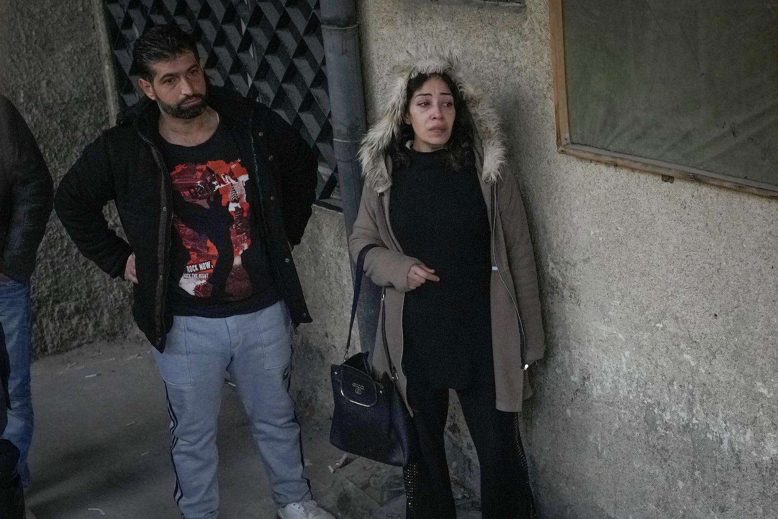 Mourners stand outside the morgue at the Al-Mojtahed Hospital in Damascus, Syria, Wednesday, Dec. 11, 2024. Many are flocking to morgues, hoping to identify loved ones who were either killed or imprisoned under President Bashar Assad's government, which collapsed over the weekend. (AP Photo/Hussein Malla)