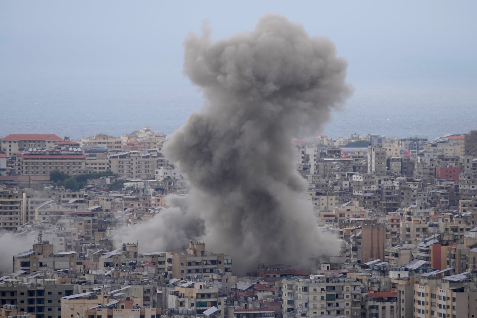 Smoke rises between buildings hit in a Israeli airstrike in Dahiyeh, in the southern suburb of Beirut, Lebanon, Sunday, Nov. 17, 2024. (AP Photo/Hussein Malla)