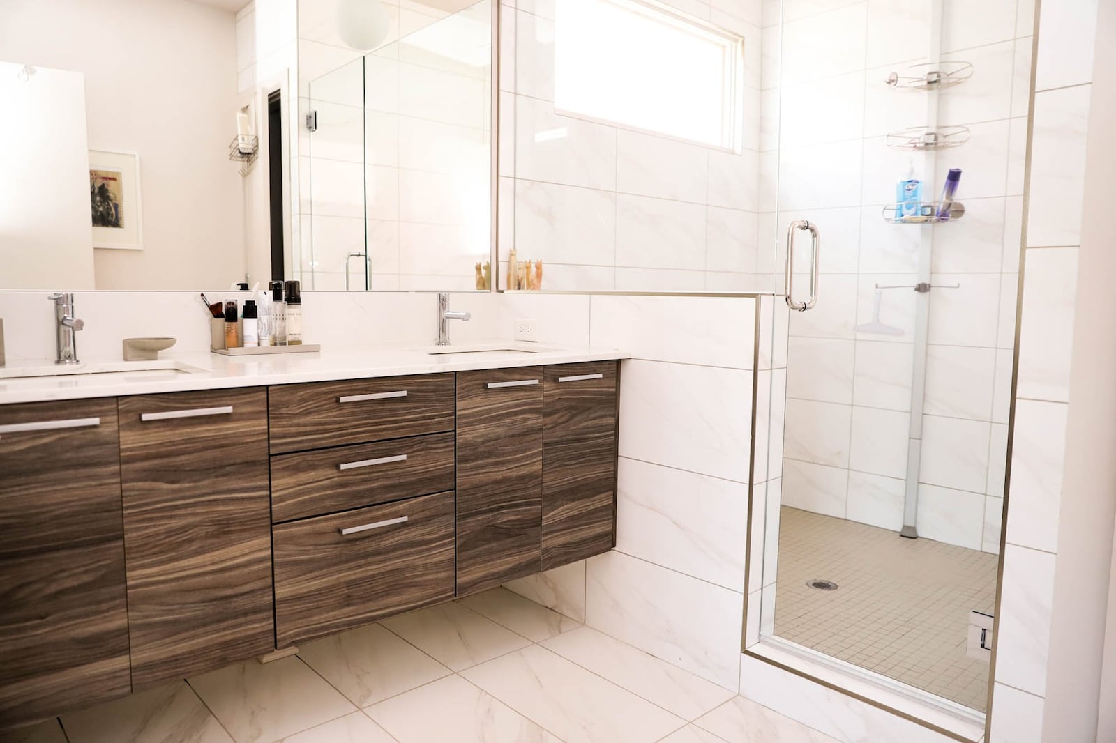 Homeowners Anja and Jumbe Sebunya love their master bathroom. "It's very sleek, not fussy, clean lines. I just like it," Anja said. "The lighting is great." Text by Shannon Dominy. Photo by Reynolds Rogers.