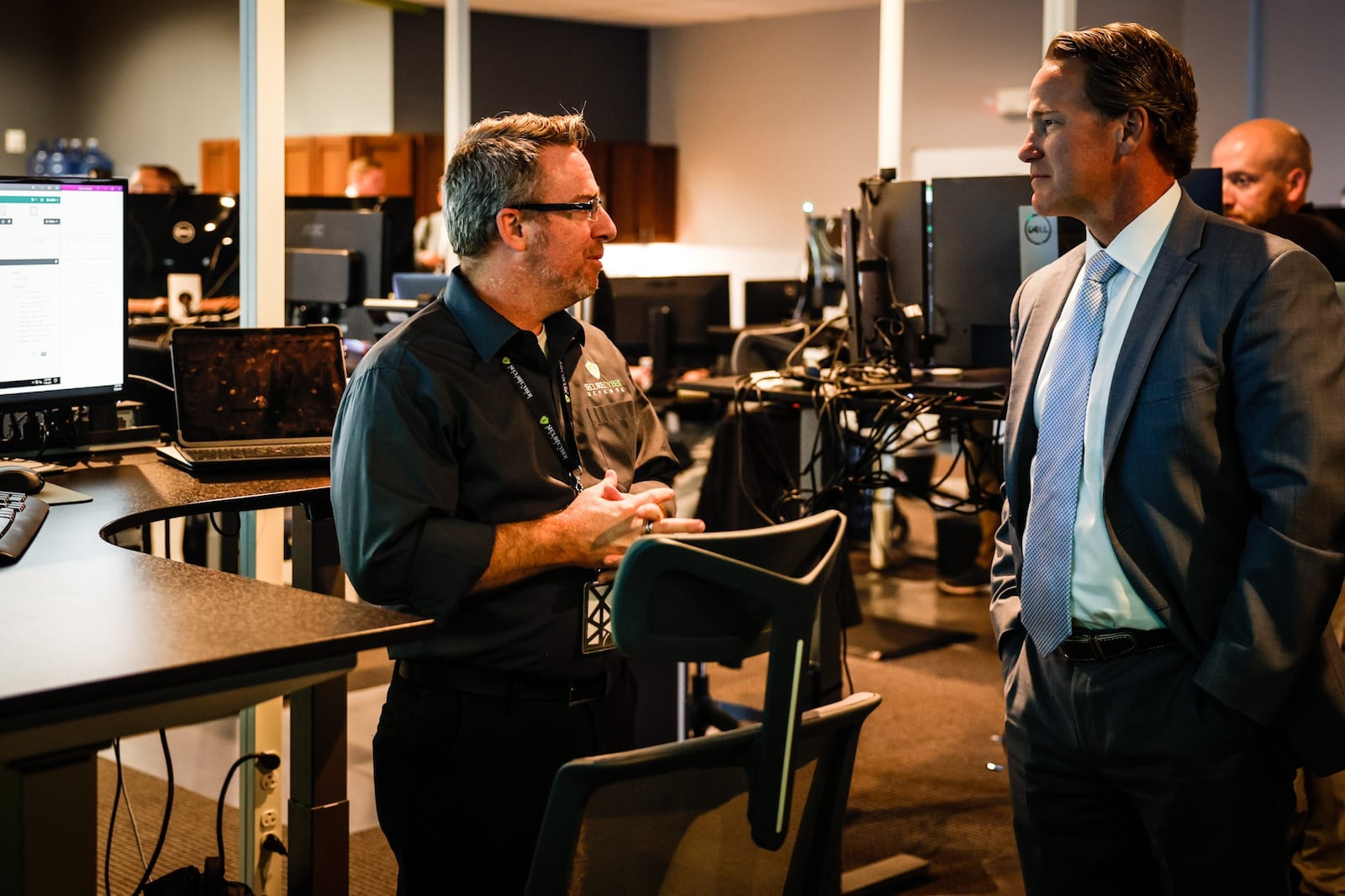 Securecyber Defense Infrastructure Engineer, Daron Holland talks with Lt. Governor, Joh Husted during a tour of the Miamisburg company Wednesday July 28, 2021. JIM NOELKER/STAFF