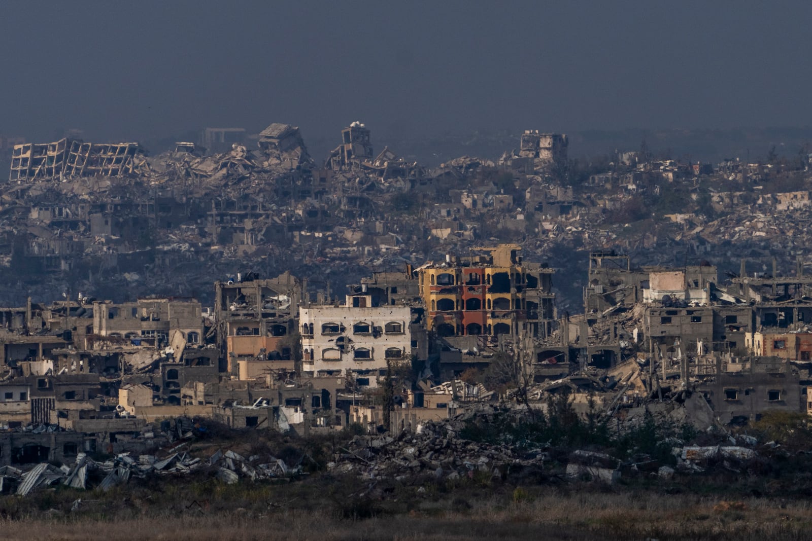 Destroyed buildings by Israeli bombardments as seen inside the Gaza Strip from southern Israel, Thursday, Jan. 16, 2025. (AP Photo/Ariel Schalit)