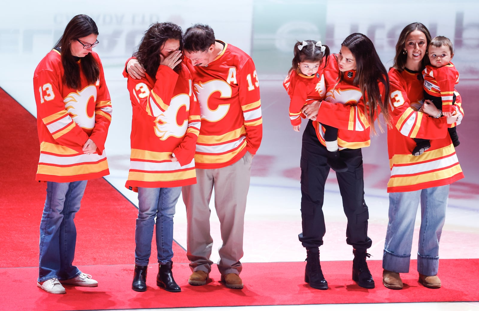 The family of Johnny Gaudreau gather at centrer ice prior before an NHL hockey game between with Calgary Flames and Columbus Blue Jackets in Calgary, Albertam Tuesday, Dec. 3, 2024. (Jeff McIntosh/The Canadian Press via AP)