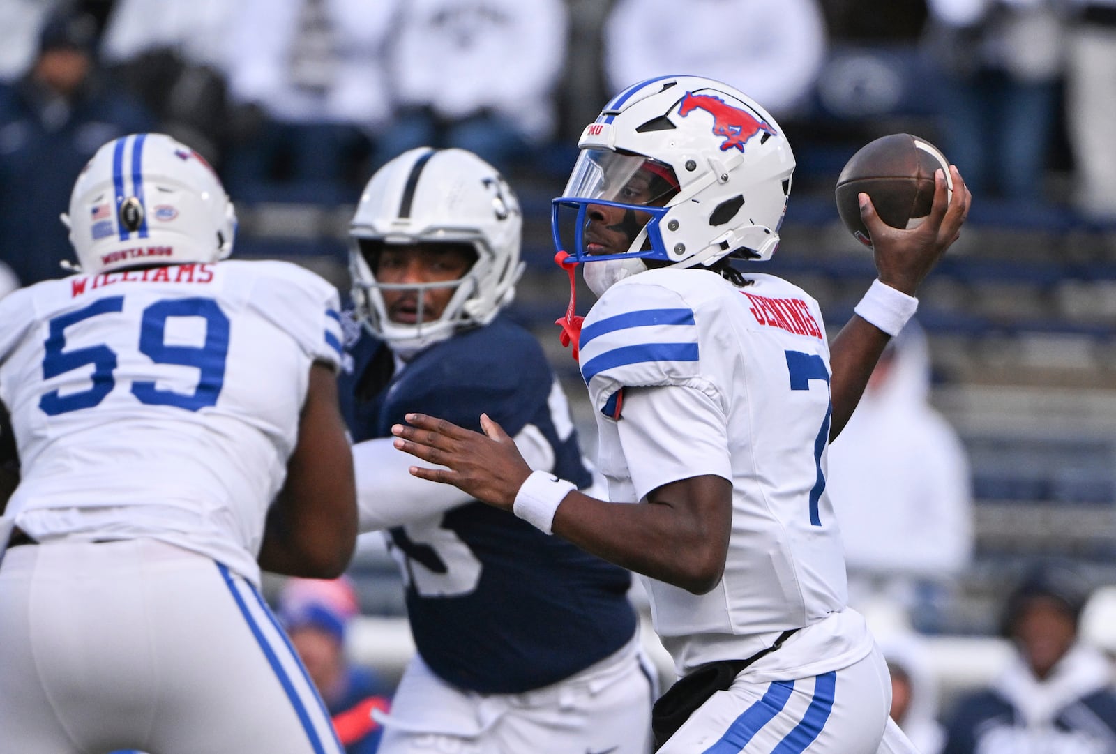 SMU quarterback Kevin Jennings (7) throws a pass while being pressured by Penn State defensive end Dani Dennis-Sutton (33) during the first half in the first round of the College Football Playoff, Saturday, Dec. 21, 2024, in State College, Pa. (AP Photo/Barry Reeger)