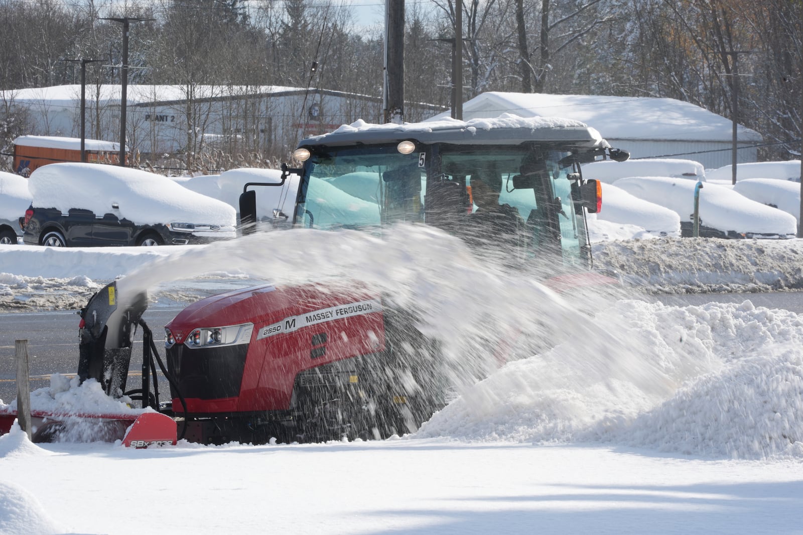 A man clears a path through the snow using a tractor in Elma, N.Y., Monday, Dec. 2, 2024. (AP Photo/Gene J. Puskar)