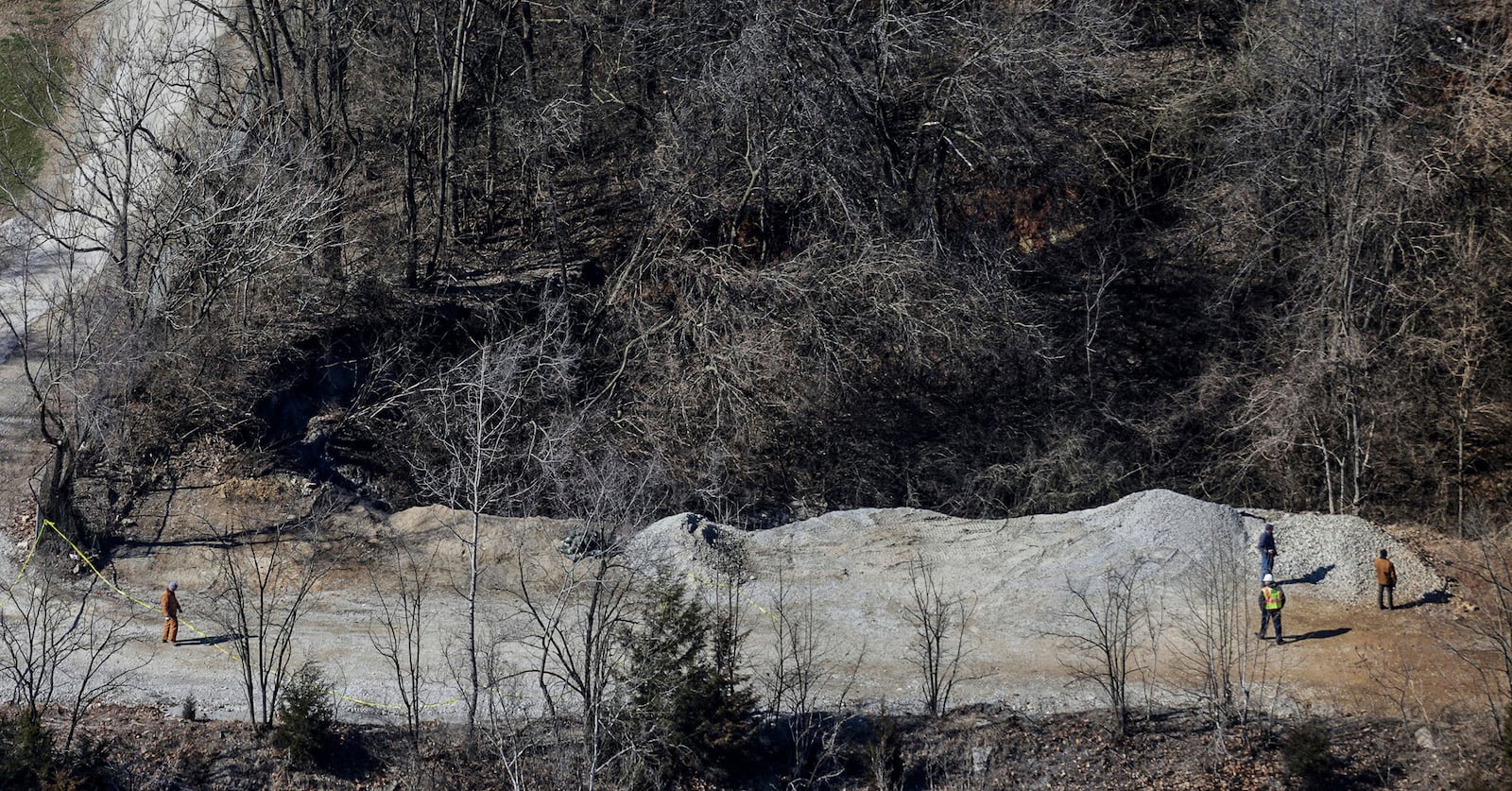 FILE - Officials stand on one edge of a giant sinkhole on the property of the Louisville Zoo, Wednesday, March 6, 2019, in Louisville, Ky. (Jeff Faughender/Courier Journal via AP, File)