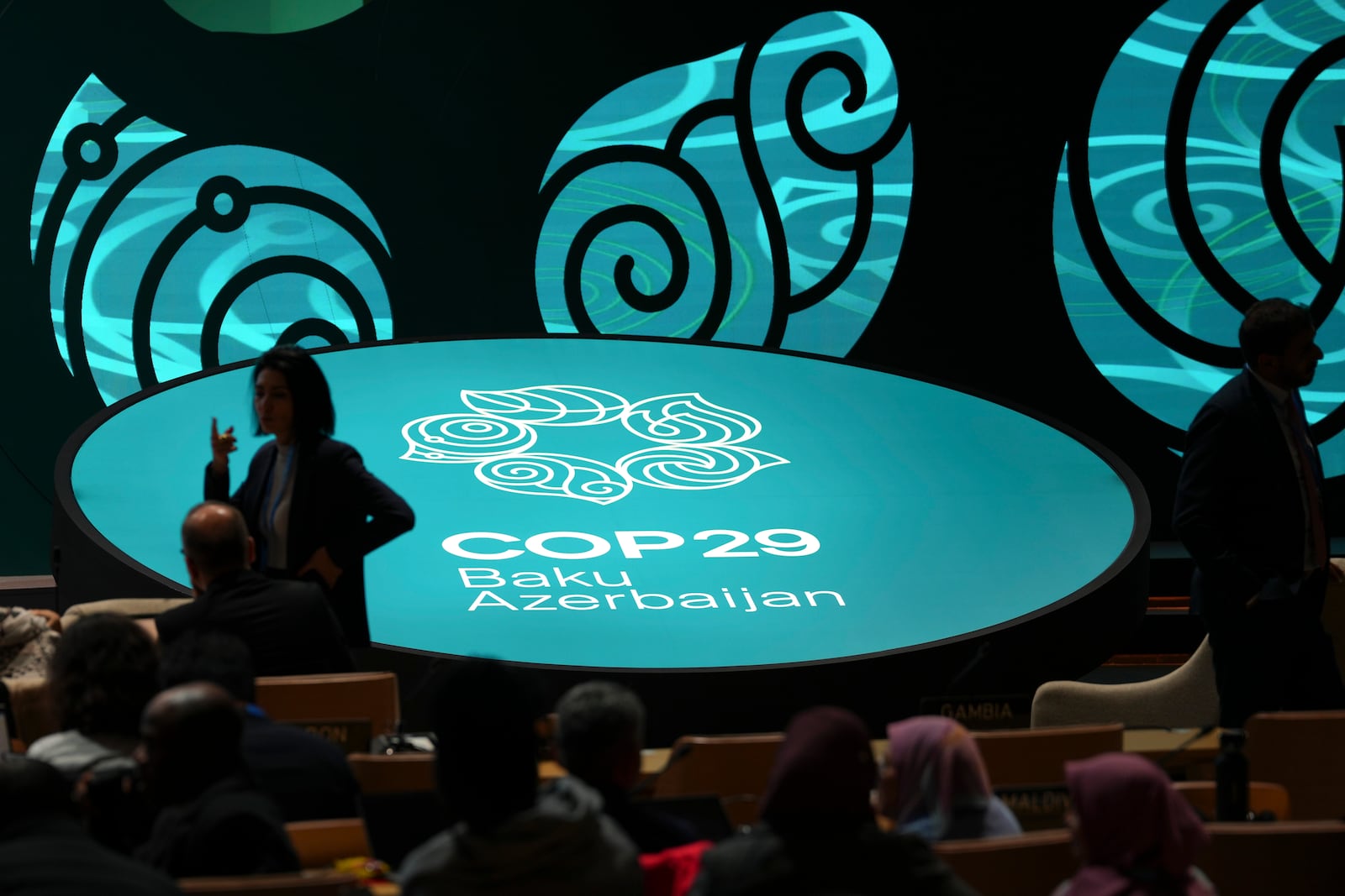 People arrive for an opening plenary session at the COP29 U.N. Climate Summit, Monday, Nov. 11, 2024, in Baku, Azerbaijan. (AP Photo/Peter Dejong)