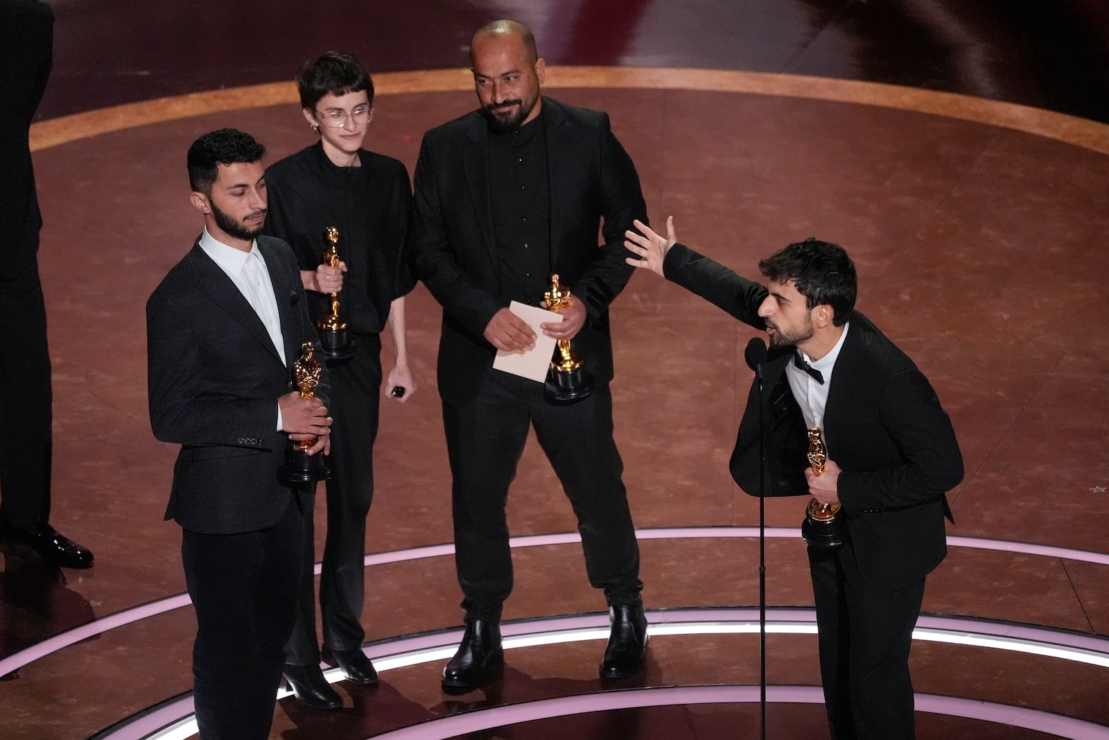 Basel Adra, from left, Rachel Szor, Hamdan Ballal, and Yuval Abraham accept the award for best documentary feature film for "No Other Land" during the Oscars on Sunday, March 2, 2025, at the Dolby Theatre in Los Angeles. (AP Photo/Chris Pizzello)