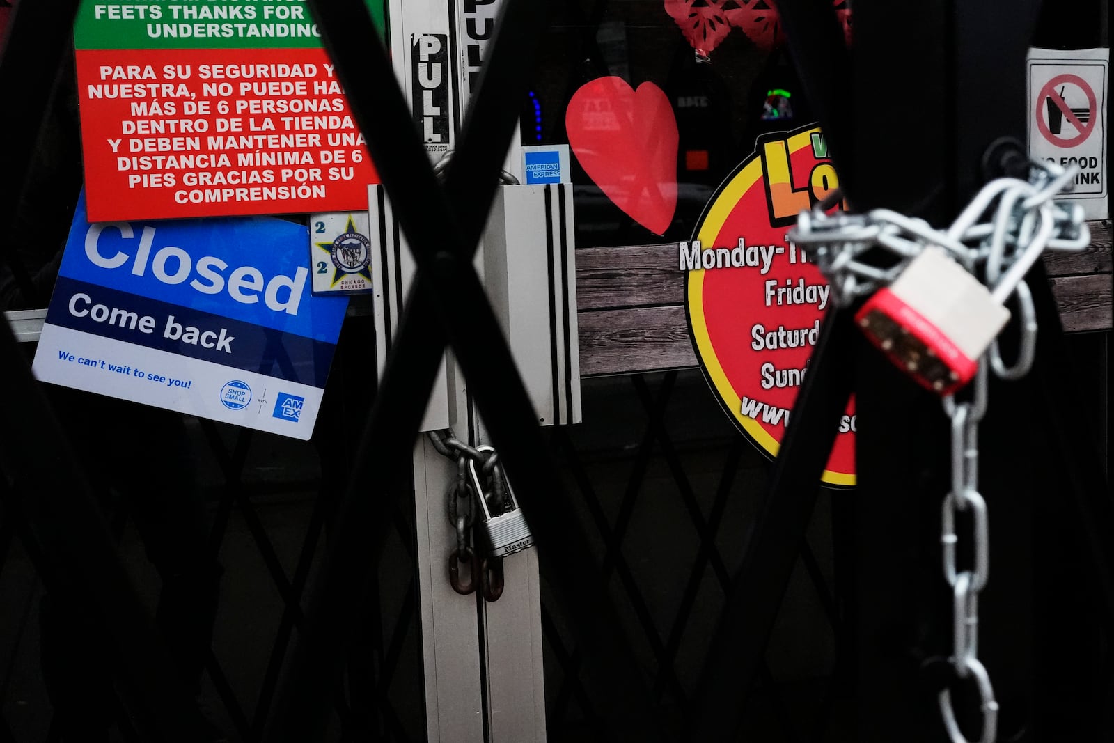 A closed sign is displayed at a mini grocery store in the Little Village neighborhood of Chicago, Monday, Feb. 3, 2025. (AP Photo/Nam Y. Huh)