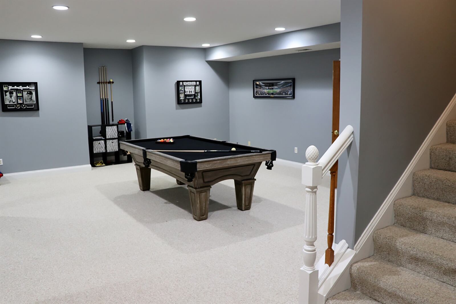 The lower level has been finished into a recreation room with several floor plan nooks that include space for a family room, game room and bar area. A hallway leads to two rooms and a full bathroom. One room is the media theater with screen and projection. CONTRIBUTED PHOTO BY KATHY TYLER