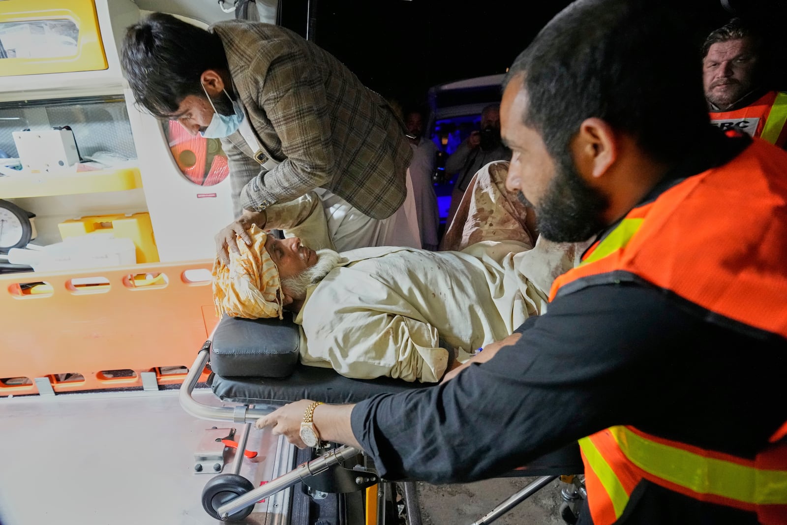 An injured passenger rescued by security forces from a passenger train attacked by insurgents is carried in an ambulance after arriving on a special train for injured and survivors organised by the army, at a railway station in Much, Pakistan's southwestern Balochistan province, Wednesday, March 12, 2025. (AP Photo/Anjum Naveed)