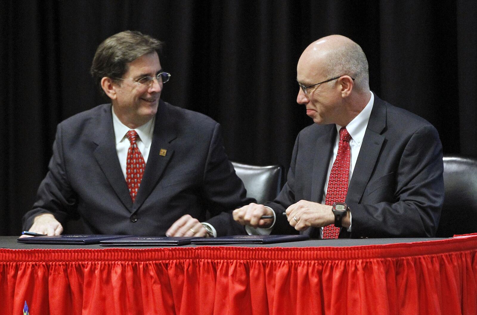 Fuyao Glass America, Inc. announced a $7 million gift to support the Univerisity of Dayton China Institute on Friday. It is the largest gift from a corporation in UD’s history. University of Dayton President Dan Curran, left, and Fuyao Glass America President John Gauthier after signing the gift agreement. TY GREENLEES / STAFF