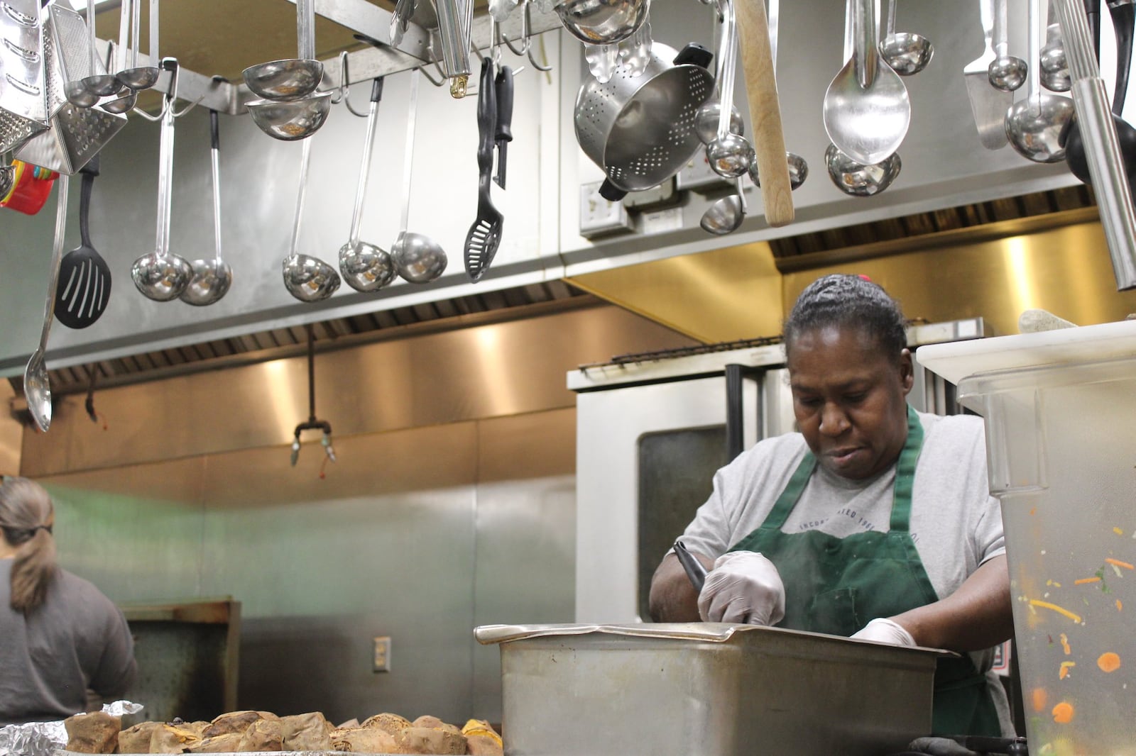 Hiacinthe Greene-Modeste, kitchen manager, prepares food at the House of Bread on Christmas. CORNELIUS FROLIK / STAFF