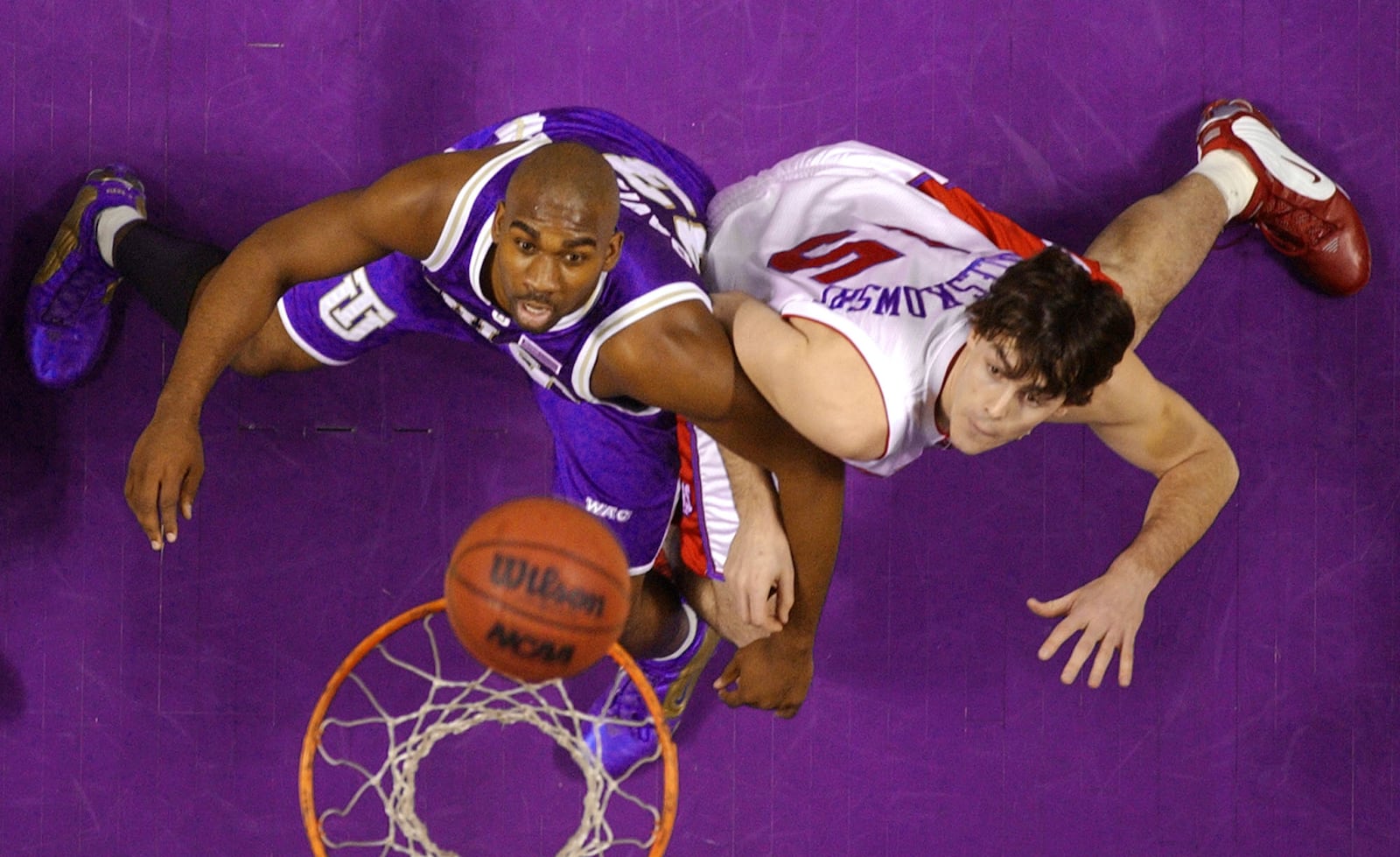 Tulsa's Charlie Davis, left, and Dayton's Logan White vie for rebounding position in the first half Thursday, March 20, 2003, in Spokane, Wash. in the first round of the men's NCAA Division I basketball championship. (AP Photo/Elaine Thompson)