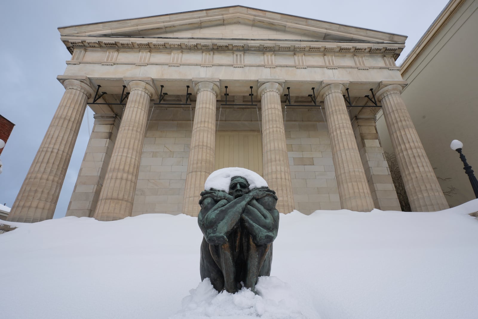 A sculpture is covered in snow on the steps of Erie Art Museum Tuesday, Nov. 5, 2024 in Erie, Pa. (AP Photo/Gene J. Puskar)