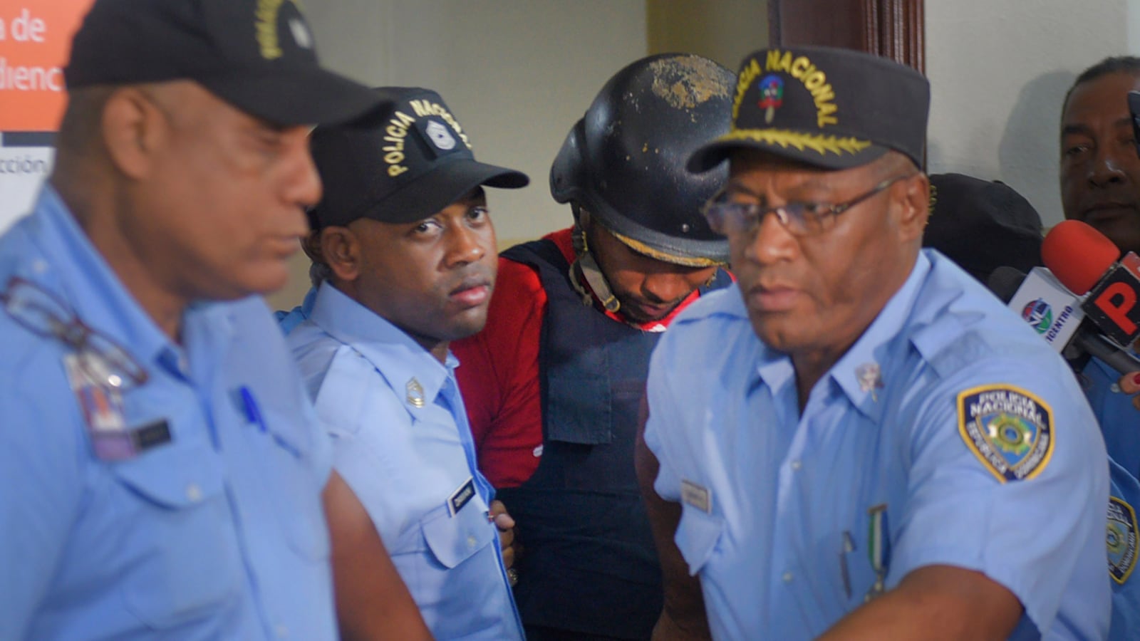 Gabriel Alexander Pérez Vizcaino, alias "Bone," behind wearing a helmet, a suspect in the shooting of former Boston Red Sox slugger David Ortiz, is taken to court in Santo Domingo, Dominican Republic, Monday, June 17, 2019. Ortiz was shot in the back at a bar in the Dominican Republic on Sunday, June 9.