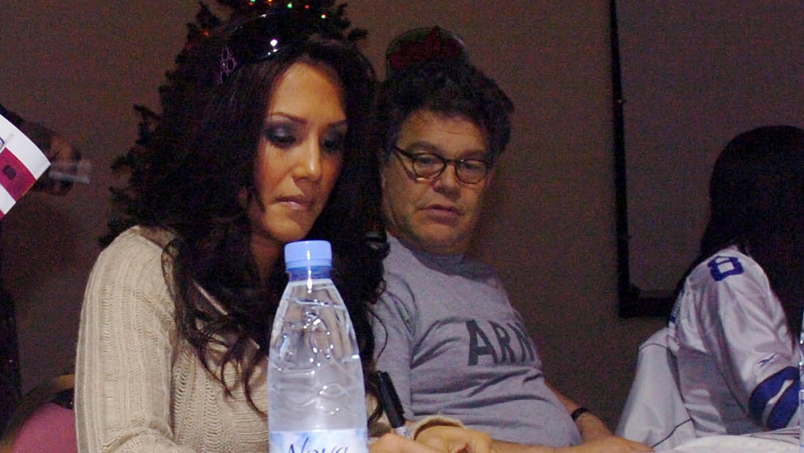 Int his image provided by the U.S. Army, sportscaster Leeann Tweeden and then-comedian Al Franken meet and greet military members during an autograph signing session of the USO Sergeant Major of the Army's 2006 Hope and Freedom Tour in Camp Arifjan, Kuwait, on Dec. 14, 2006. Sen. Al Franken, D-Minn., apologized Nov. 16, 2017, after Tweeden accused him of forcibly kissing her during the 2006 USO tour. Colleagues, including fellow Democrats, urged a Senate ethics investigation. Tweeden also accused Franken of posing for a photo with his hands on her breasts as she slept, while both were performing for military personnel two years before Franken was elected to the Senate. (Sgt. Thomas Day/U.S. Army 40th via AP)