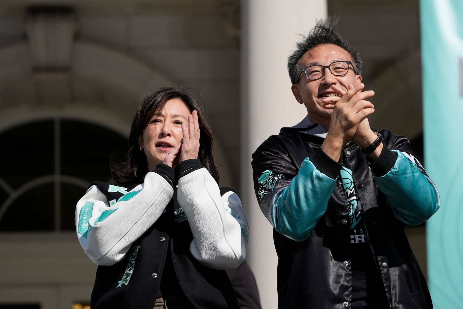 New York Liberty owners Clara Wu Tsai and Joe Tsai applaud during a ceremony after a parade in honor of the Liberty's WNBA basketball championship at City Hall in New York, Thursday, Oct. 24, 2024. (AP Photo/Seth Wenig)