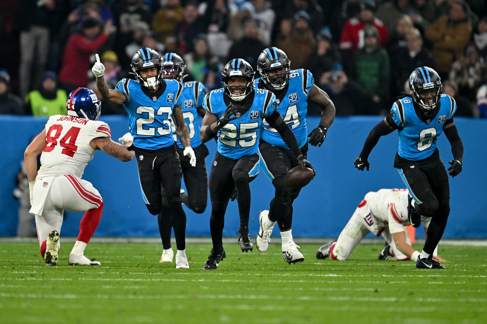 Carolina Panthers safety Xavier Woods intercepts a pass against the New York Giants during the first half of an NFL football game, Sunday, Nov. 10, 2024, in Munich, Germany. (AP Photo/Lennart Preiss)