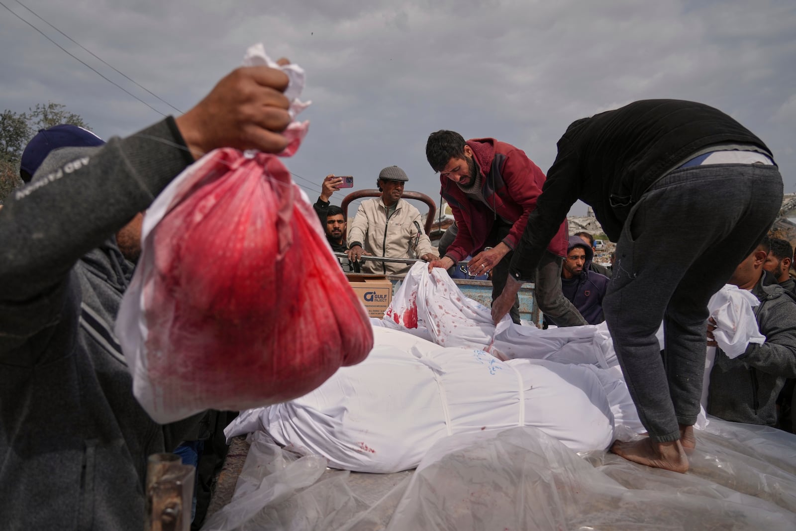 The bodies of victims of an Israeli army airstrike arrive for burial at the Indonesia Hospital in Beit Lahia, northern Gaza Strip, Thursday, March 20, 2025. (AP Photo/Jehad Alshrafi)