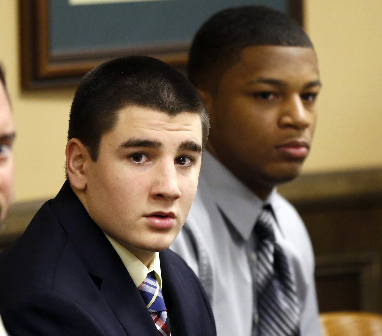 Central State football player Trent Mays, left, and Ma’lik Richmond, right, sit at the defense table before the start of their trial on rape charges in juvenile court in Steubenville, Ohio. Although both were convicted, they are not on the sex offender registry because their conventions came as juveniles. (AP Photo/Keith Srakocic)