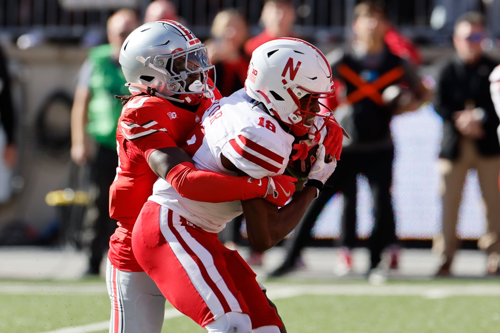 Ohio State defensive back Denzel Burke, left, tackles Nebraska receiver Isaiah Neyor during the second half of an NCAA college football game Saturday, Oct. 26, 2024, in Columbus, Ohio. (AP Photo/Jay LaPrete)