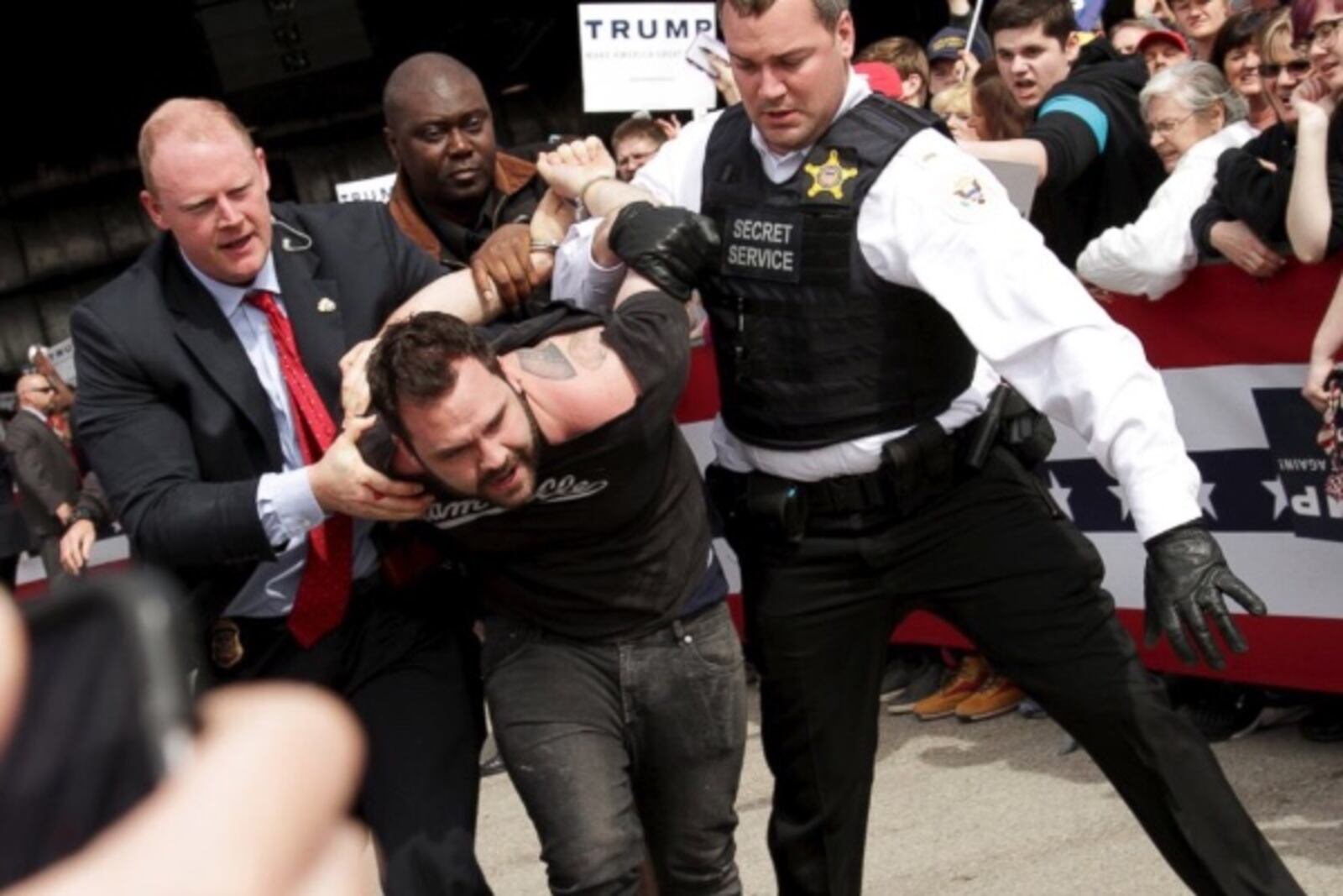 Tommy DiMassimo being hauled away by Secret Service agents.