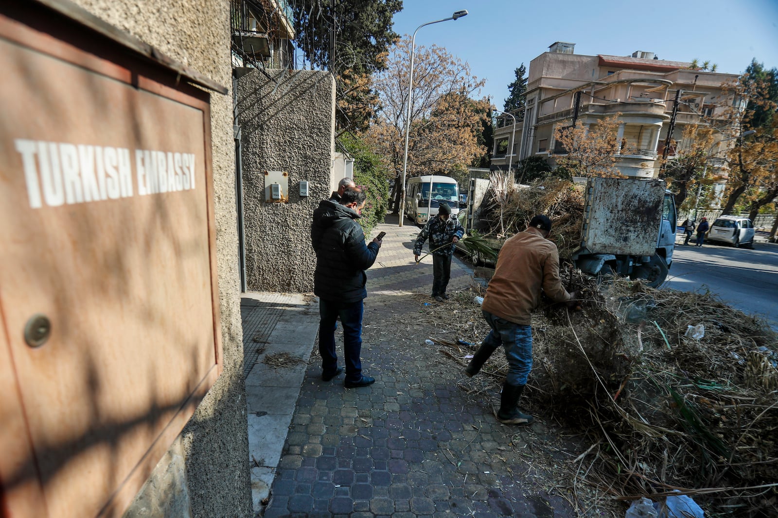 Workers clean outside the Turkish embassy in Damascus, Syria, Saturday, Dec. 14, 2024. (AP Photo/Omar Sanadiki)