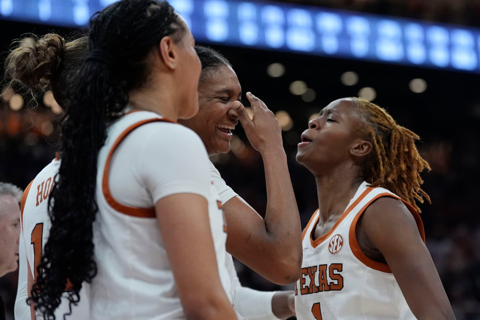 Texas forward Madison Booker, center, celebrates after a play with teammate Bryanna Preston, right, during the second half of an NCAA college basketball game in Austin, Texas, Sunday, Feb. 9, 2025. (AP Photo/Eric Gay)