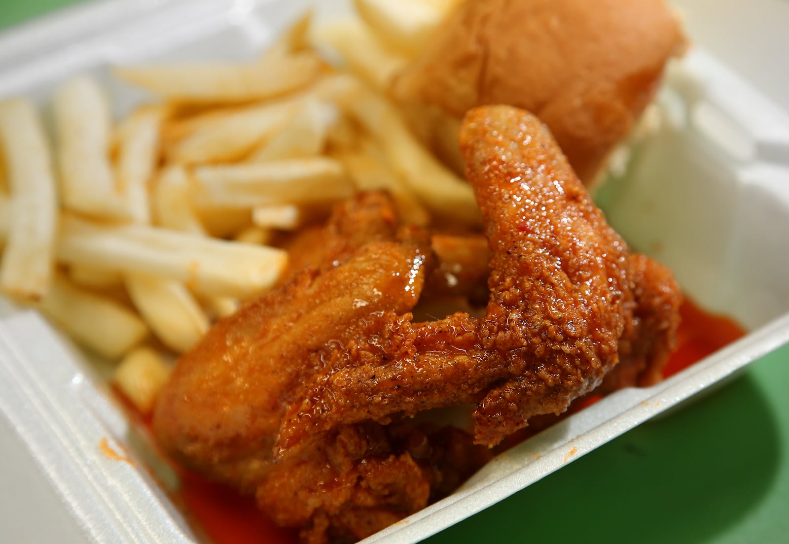 Holly wings with fries from Courtland's Mobile Grill. The dish is made with special "Holly Sauce," named after the founder's daughter, and comes with fries and a roll. Guy C. Ansley founded Courtland’s Mobile Grill in 2006. He is a staple on Courthouse Square and around Dayton and is known for his ribs, fish, wings and tenders. LISA POWELL / STAFF